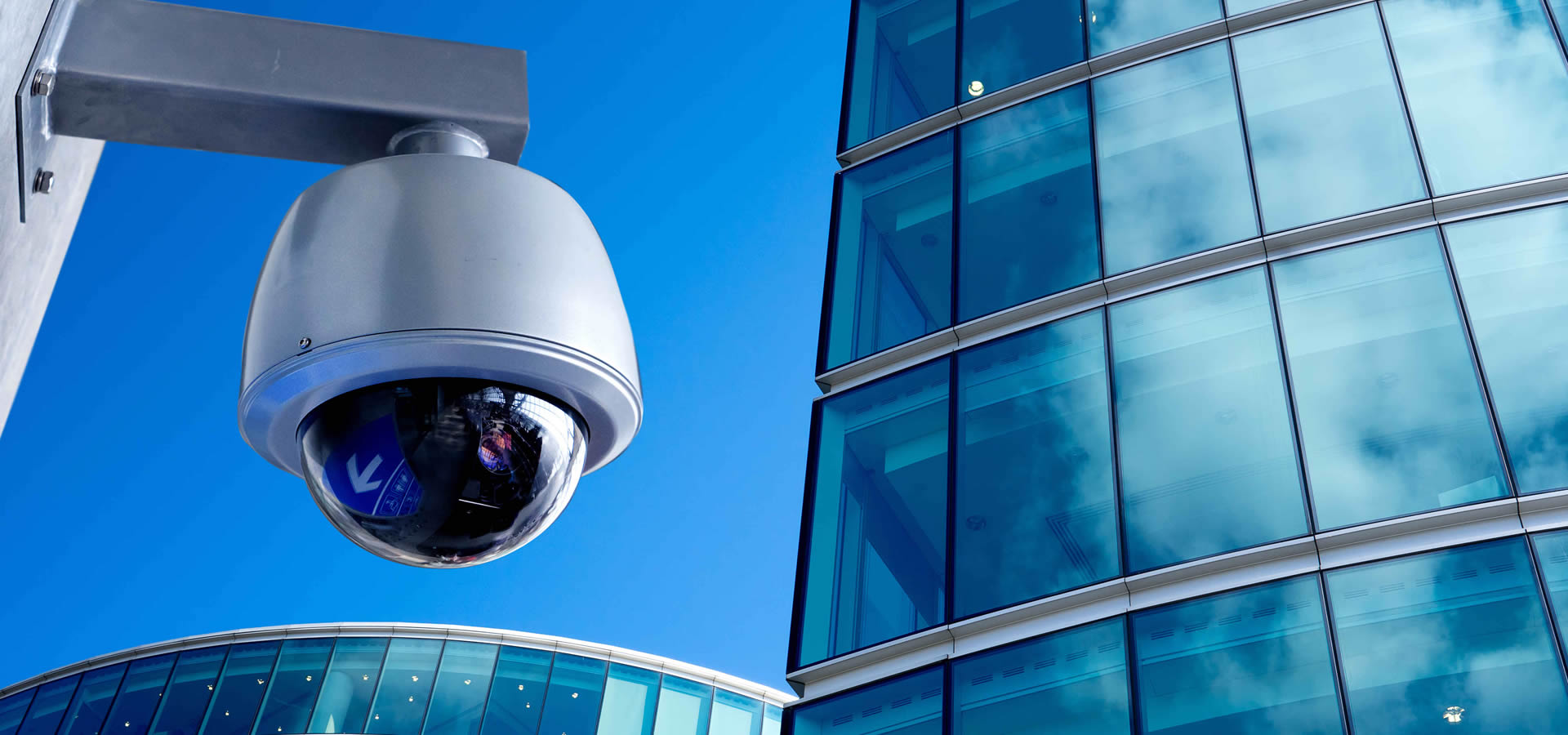 CCTV outdoors on side of modern glass building
